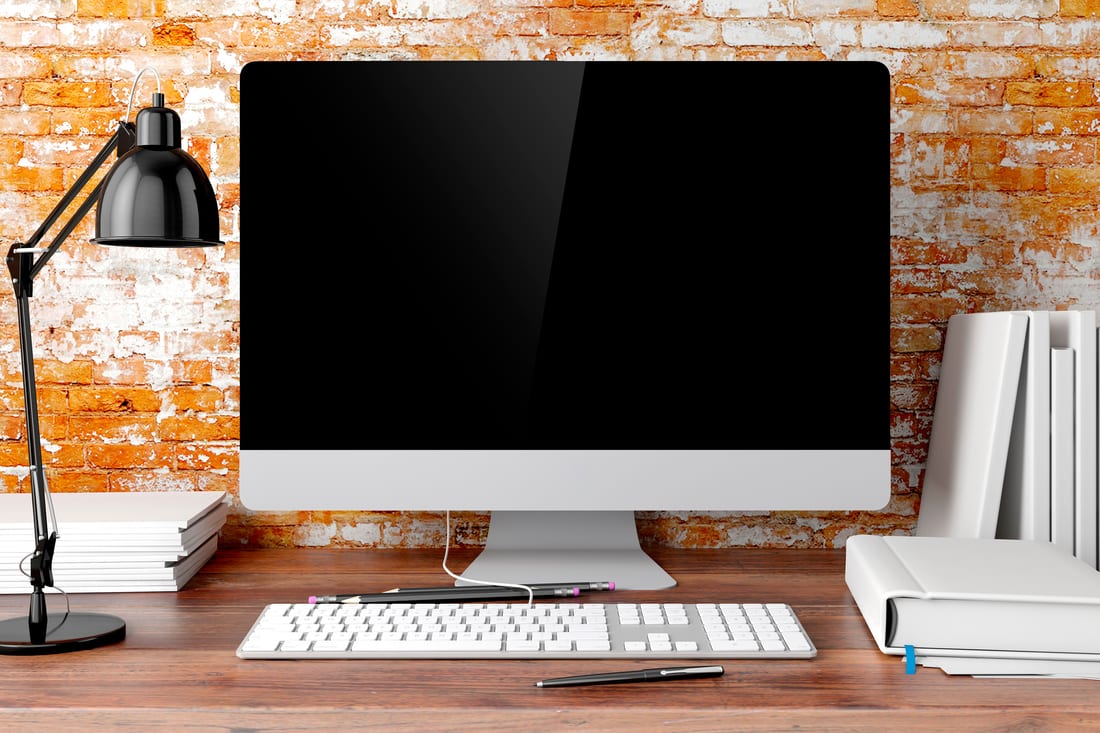 Desktop computer on a desk displaying a published article